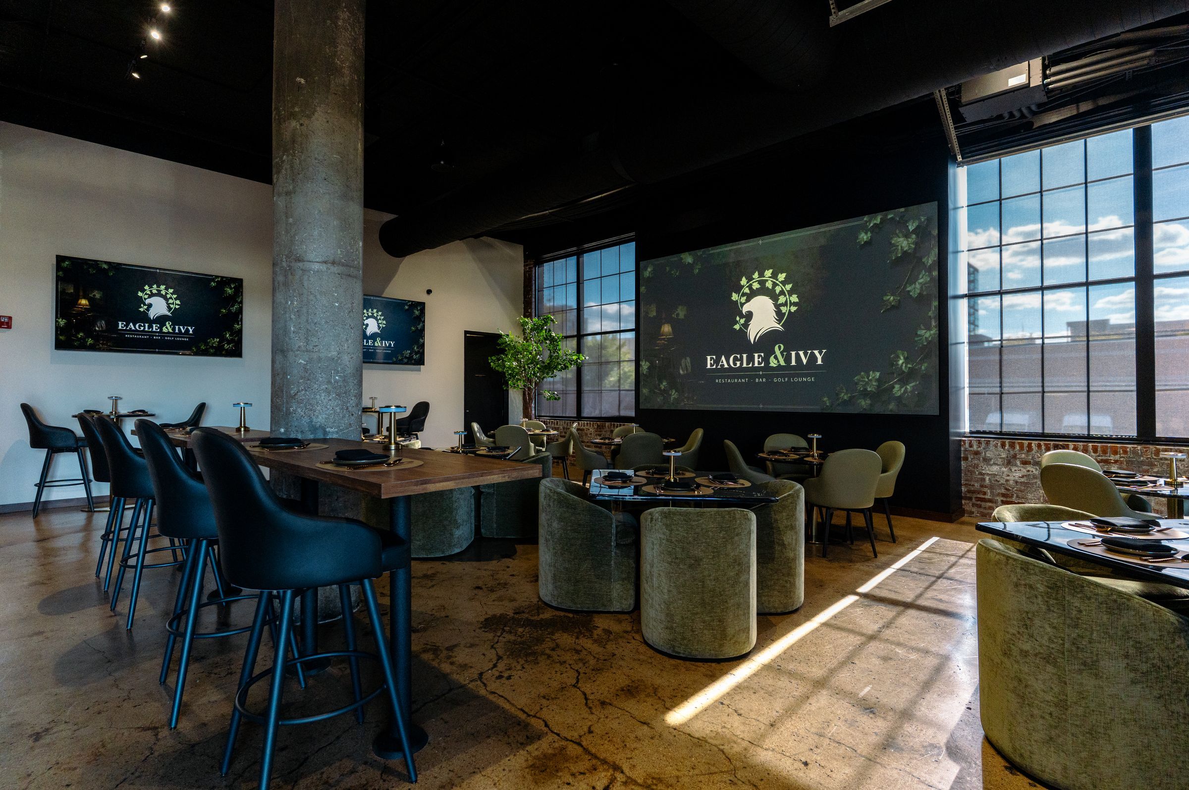 The Eagle & Ivy dining room, with the logo on the video wall